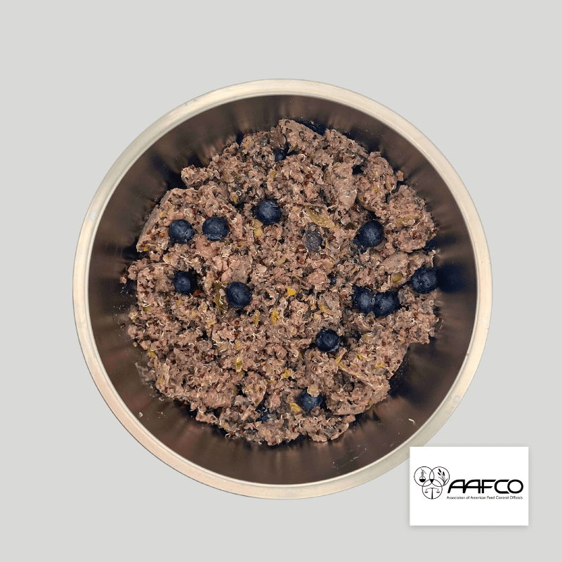 Gently cooked dog food featuring venison, quinoa, and blueberries in a metal bowl, displaying AAFCO certification.